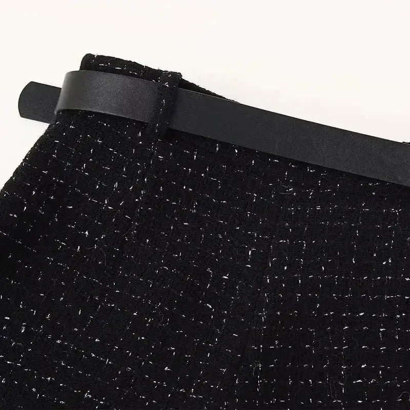 Black textured fabric with belt loop detail from cropped vest and high waist shorts set