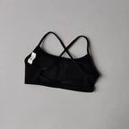 Black cross back sports bra designed for comfort and flexibility during workouts