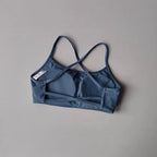 Stylish cross back sports bra in blue, perfect for workouts and active wear