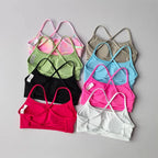 Colorful assortment of cross back sports bras in various shades for comfortable activewear
