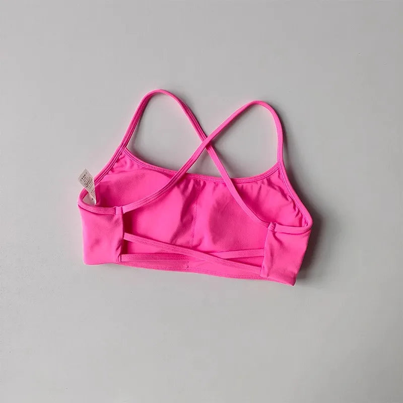 Bright pink cross back sports bra with adjustable straps for comfortable workouts