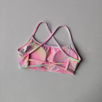 Colorful cross back sports bra from The Lady's Haven Boutique, featuring a stylish design for active wear