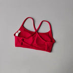 Red cross back sports bra with adjustable straps for comfort and support during workouts