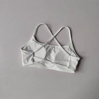 White cross back sports bra with soft fabric and stylish cross-back design for comfort and support