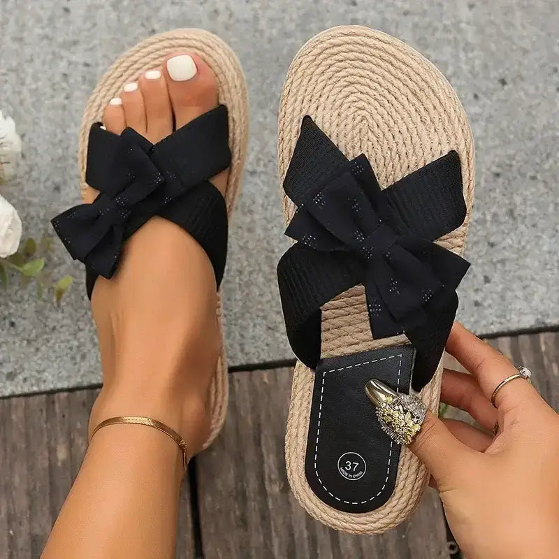 The Lady's Haven Boutique flat heel cross strap comfort sandals with black bows on textured sole
