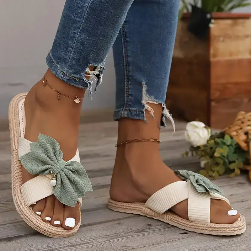 The Lady's Haven Boutique flat heel cross strap comfort sandals with large green bow detail