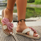 The Lady's Haven Boutique flat heel cross strap comfort sandals with pink bow detail on natural sole