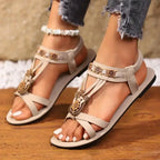 The Lady's Haven Boutique beige cross strap soft sole sandals with floral embellishments and flat heel