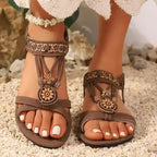 The Lady's Haven Boutique brown cross strap soft sole sandals with floral accents and flat heel