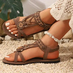 The Lady's Haven Boutique brown cross strap soft sole sandals with floral details on feet