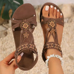 Brown flat heel cross strap soft sole sandals with floral embellishments from The Lady's Haven Boutique