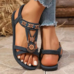 The Lady's Haven Boutique cross strap soft sole sandals with floral embellishments and flat heel in black
