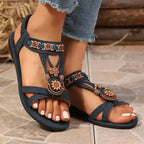 Black flat heel cross strap soft sole sandals with floral decorations from The Lady's Haven Boutique