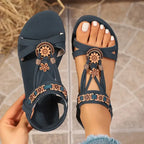 The Lady's Haven Boutique cross strap soft sole sandals with floral embellishments in navy blue flat heel