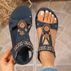 Cross strap soft sole sandals in navy blue with floral embellishments from The Lady's Haven Boutique