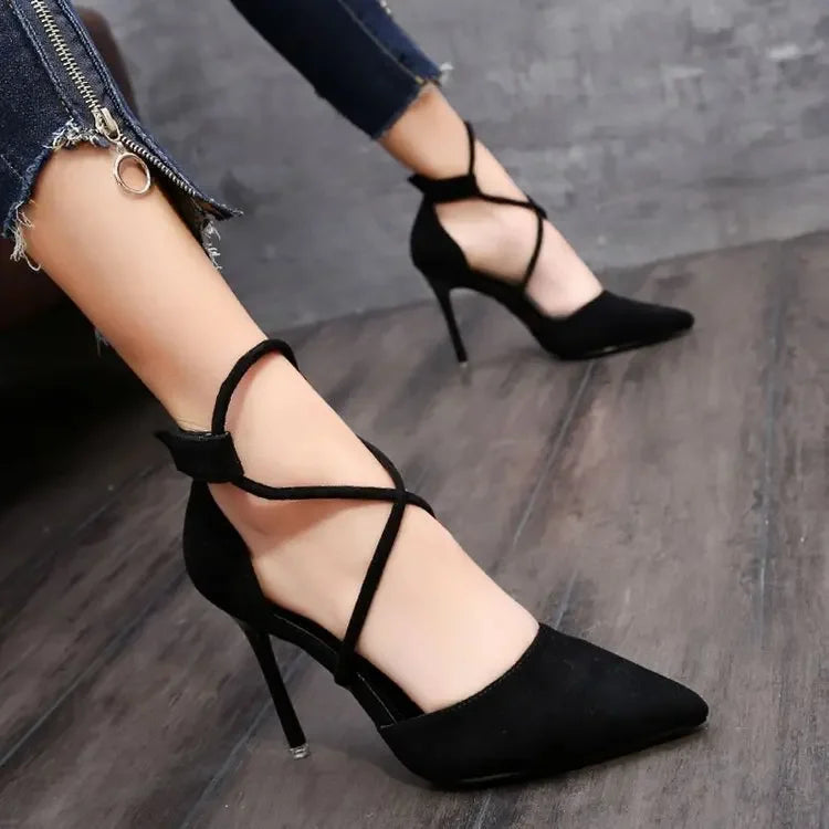 Black cross strap suede high heels with pointed toe and stiletto heel worn with cropped jeans
