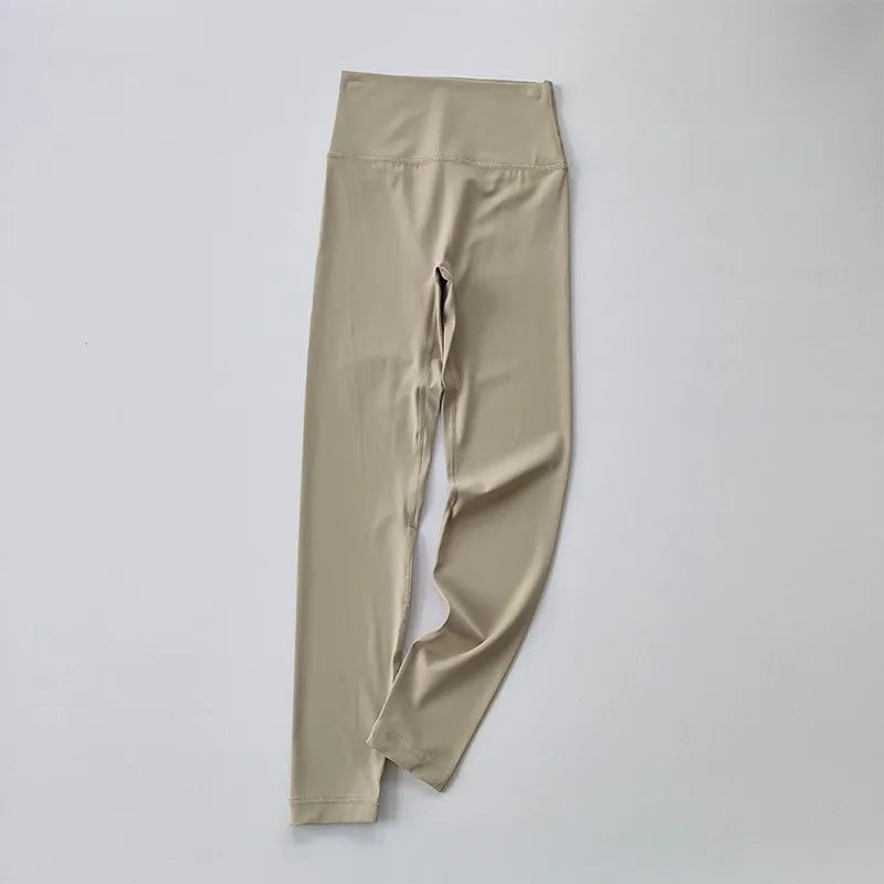 Beige elastic fitness leggings for women with a high waistband for comfort during workouts