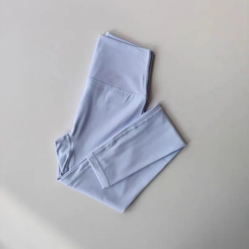 Light blue elastic fitness leggings for women with a comfortable waistband and breathable fabric