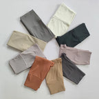 Variety of elastic fitness leggings for women in multiple colors and styles arranged flat