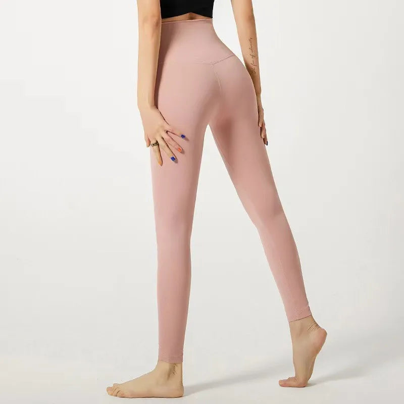 Stylish pink elastic fitness leggings for women with a high waistband and a sleek fit