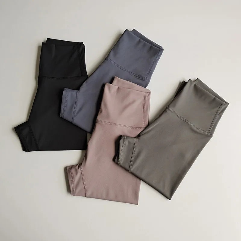 Set of three elastic fitness leggings for women in black, gray, and pink perfect for workouts