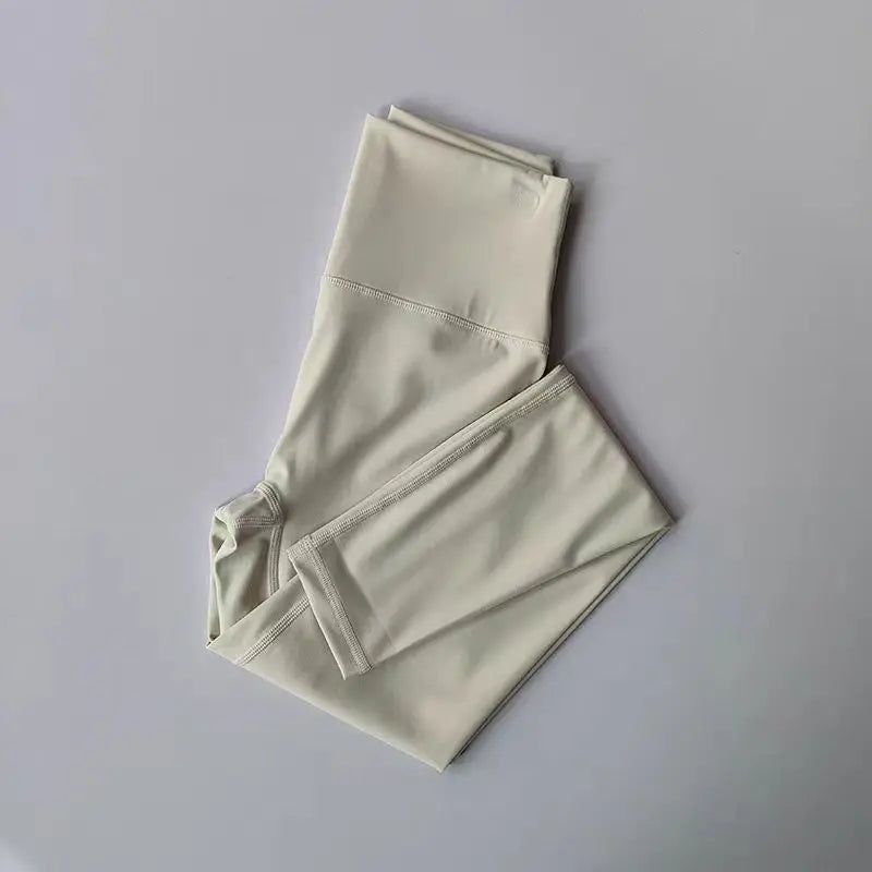 Light beige elastic fitness leggings for women with a comfortable and stretchy design
