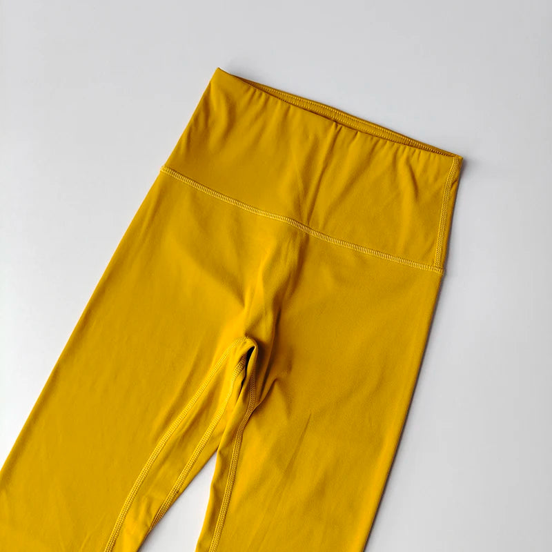 Bright yellow elastic fitness leggings for women with a high waistband for comfort and support