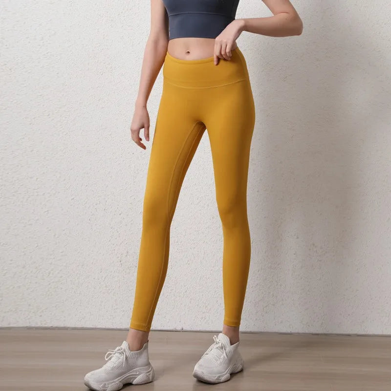Stylish mustard elastic fitness leggings for women with a high waist design for active workouts