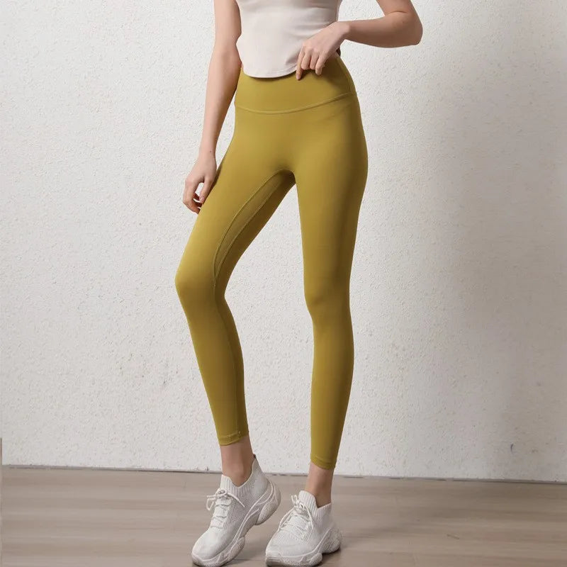 Stylish elastic fitness leggings for women in mustard yellow, perfect for workouts and everyday wear