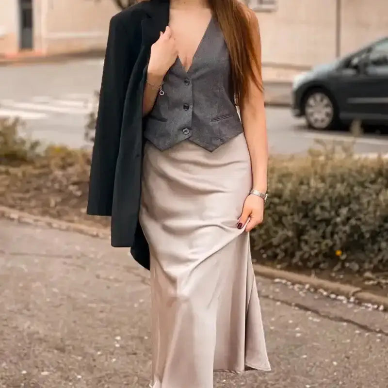 Elegant ladies evening skirt in satin fabric paired with a gray vest and black jacket