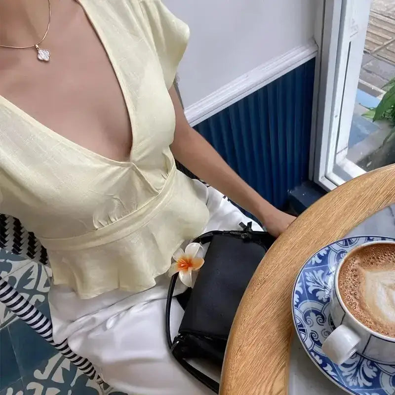 The Lady's Haven Boutique short sleeve blouse and pant set in cream with deep neckline and peplum waist