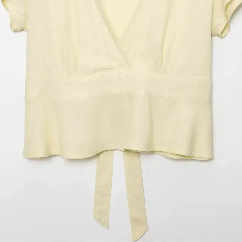 Cream short sleeve blouse and pant set with tie waist detail from The Lady's Haven Boutique