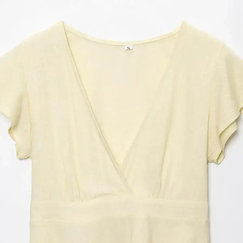 Light yellow short sleeve blouse and pant set from The Lady's Haven Boutique with a deep V neckline