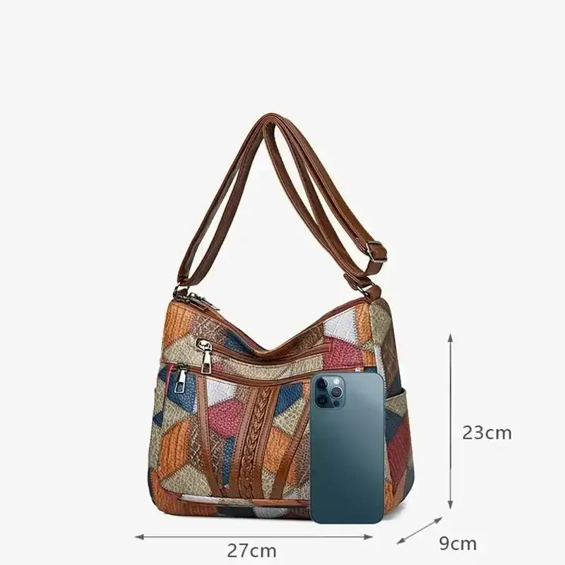 Vintage crossbody bag for women with colorful pattern and spacious design, shown with a phone for size reference