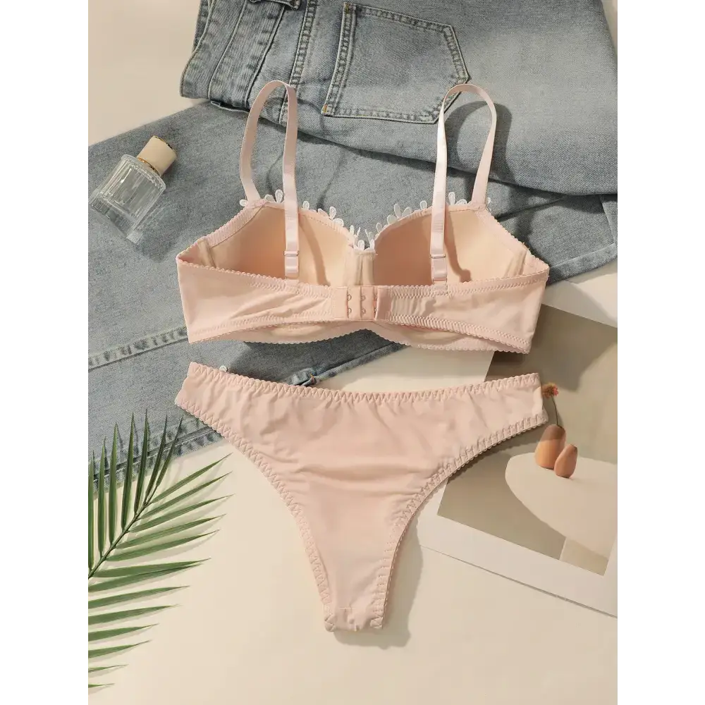 Embroidered floral underwear set in soft pink with adjustable straps and delicate lace trim