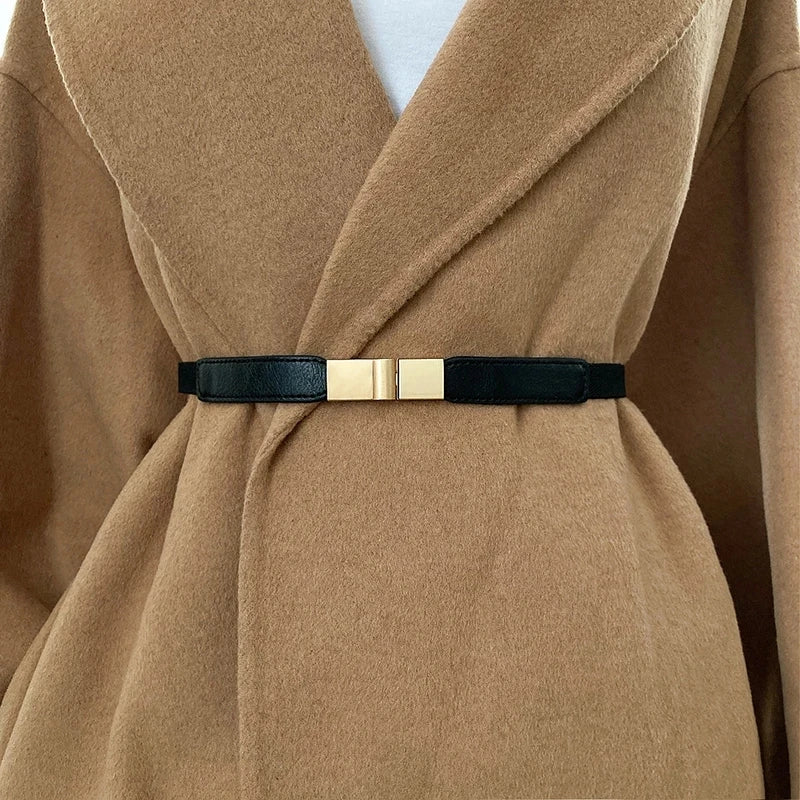 Sleek black fashion belt for dresses with a stylish gold buckle, perfect for cinching waistlines