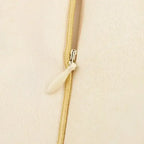 Close-up of a beige zipper detail on fashion casual skirts with print from The Lady's Haven Boutique