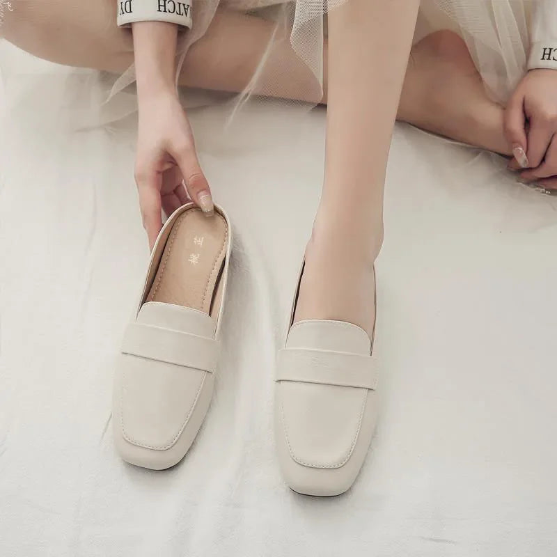 Elegant beige zapatos mujer casual slip-on flats from The Lady's Haven Boutique worn by a seated woman