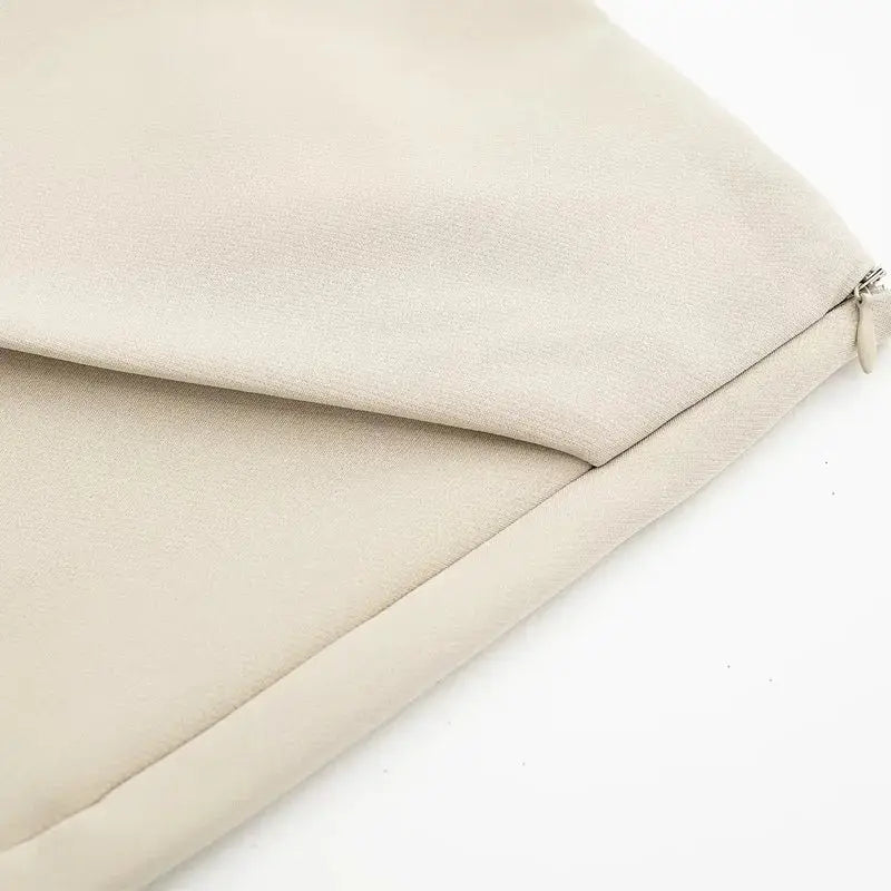 Close-up of beige fabric detail highlighting stitching and texture on fashionable skorts