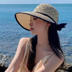 Stylish model wearing a fashionable straw hats for women by The Lady's Haven Boutique at the beach