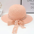 Trendy peach fashionable straw hats for women with a stylish bow detail for sunny days