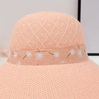 Stylish pink fashionable straw hats for women with a decorative band for summer outings