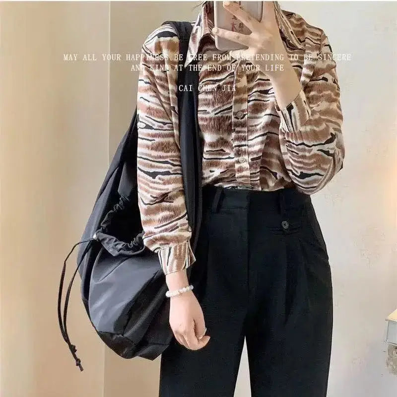 Stylish black female casual tote purse for everyday use with drawstring closure and chic design
