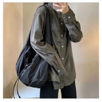 Trendy female casual tote purse shown with a model wearing a stylish button-up shirt