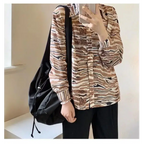 Stylish female casual tote purse paired with a fashionable blouse and relaxed pants