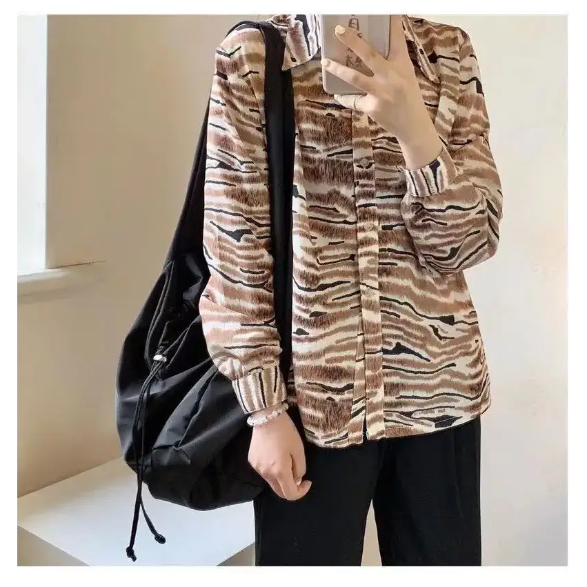 Stylish female casual tote purse paired with a fashionable blouse and relaxed pants
