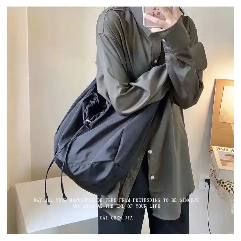Stylish black female casual tote purse with adjustable straps for everyday use