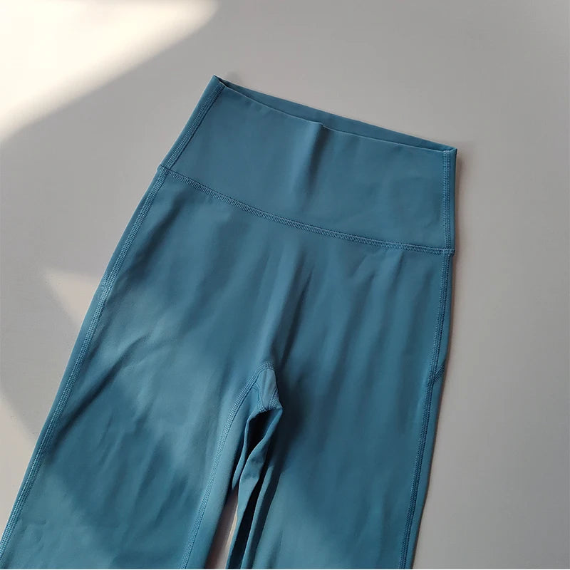Female high waist yoga leggings in teal color for comfortable and stylish workouts