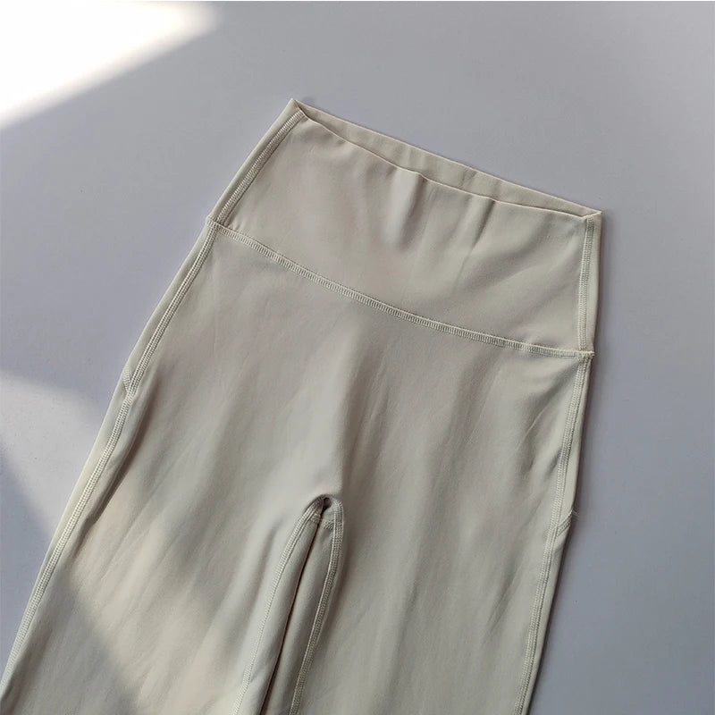 Light beige female high waist yoga leggings with a comfortable elastic waistband
