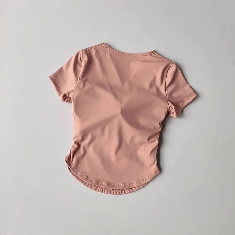 Back view of a female quick dry sports top with built in cup in soft pink color from The Lady's Haven Boutique
